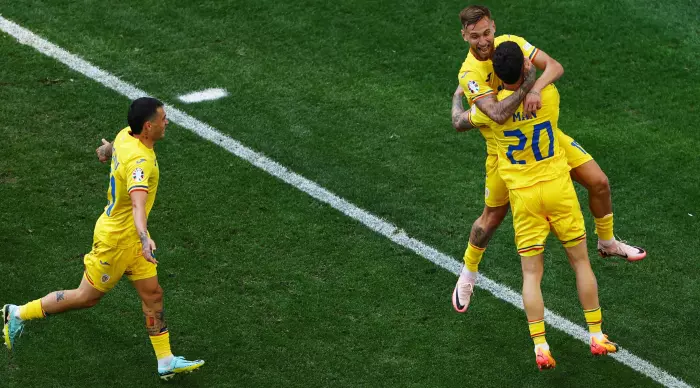 Denis Dragosh celebrates with Romanian players (Reuters)