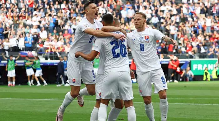 Slovakian team players celebrate the surprising goal advantage (Reuters)