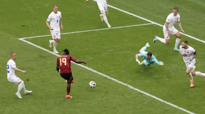 Johan Bakayoko kicks and squeezes a great save from Hancheko (Reuters)