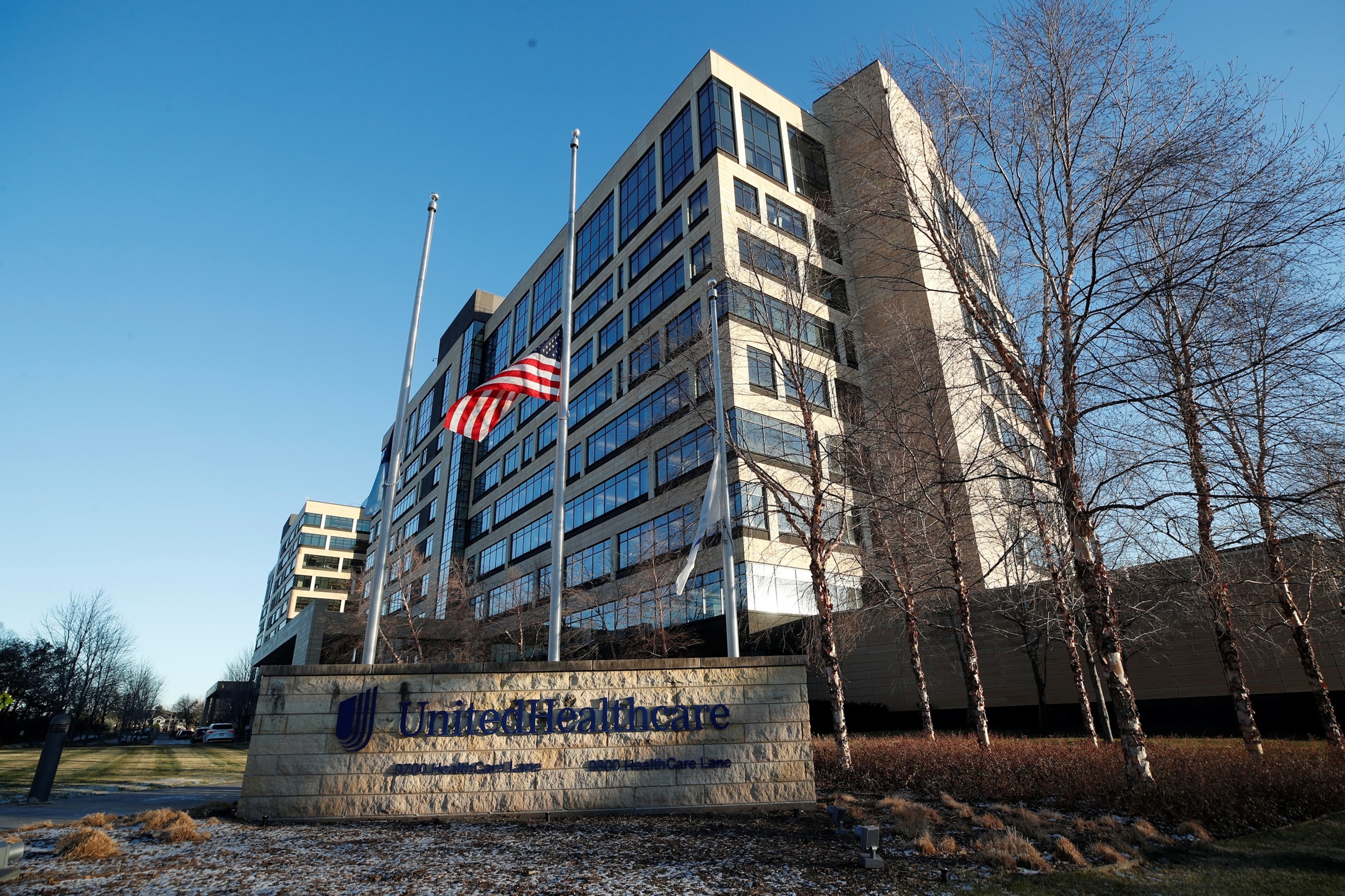 PHOTO: Flags fly at half-staff outside of the office of UnitedHealthcare in Minnetonka